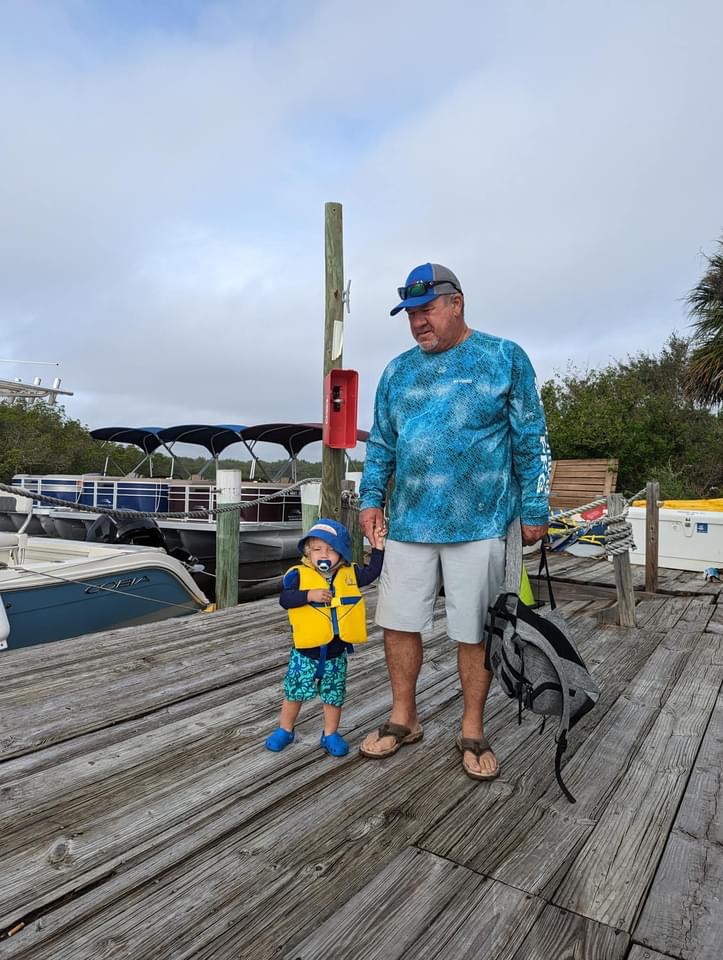 Captain D with a young first mate at the dock